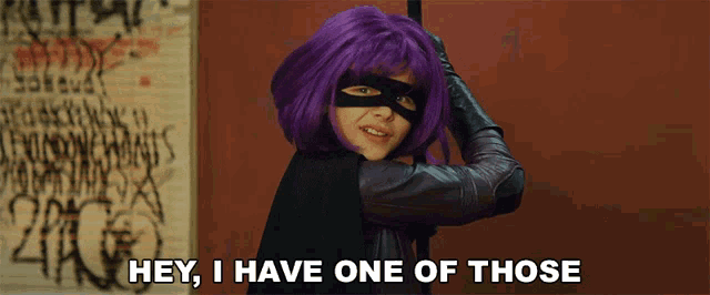 a woman with purple hair and a black mask says hey i have one of those