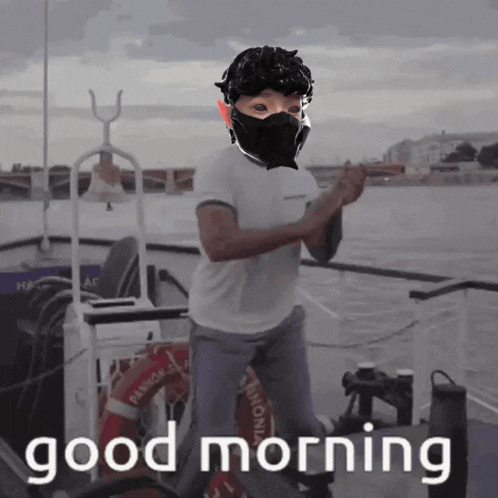 a man wearing a mask on a boat with the words good morning written below him