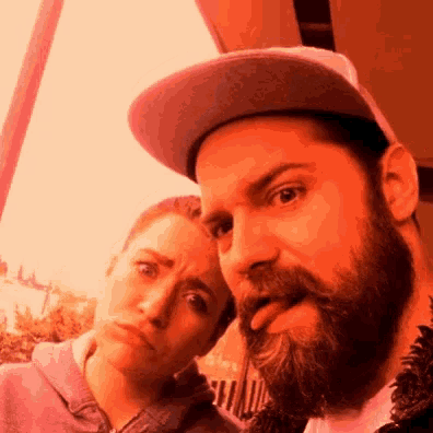 a man with a beard and a woman making a funny face