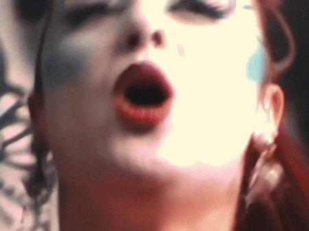a close up of a woman 's face with her eyes closed