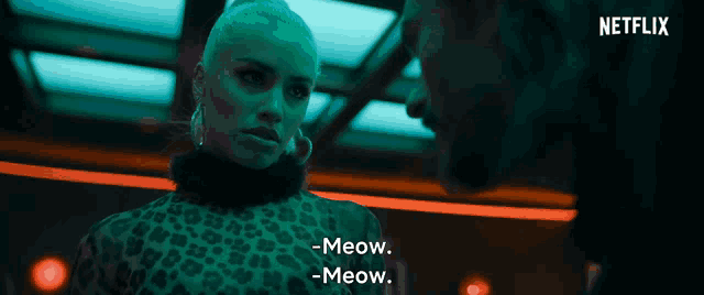 a woman in a leopard print dress says meow