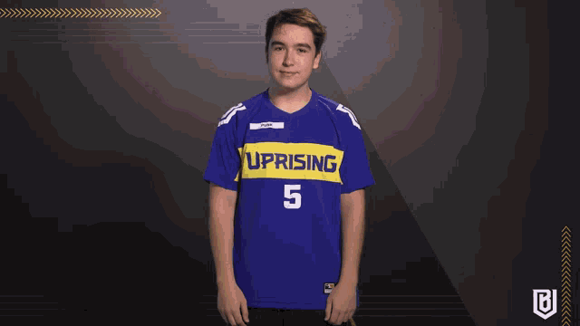 a young man wearing a blue uprising jersey