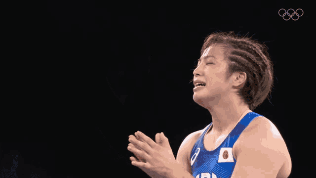 a female wrestler is wearing a blue shirt with the word lion on it
