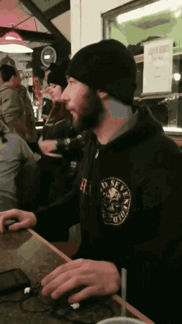 a man wearing a black sweatshirt that says seven cold