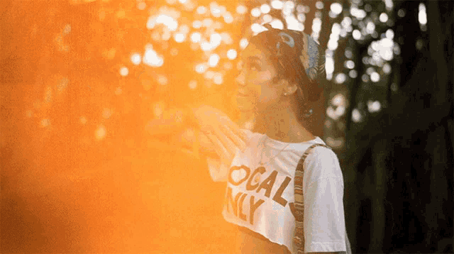 a woman wearing a white shirt that says local ny on it