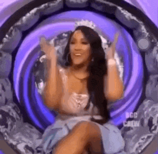 a woman is sitting in a chair with her arms outstretched in a purple circle .