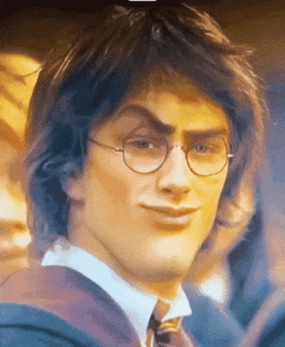 a close up of a man wearing glasses and a tie making a funny face