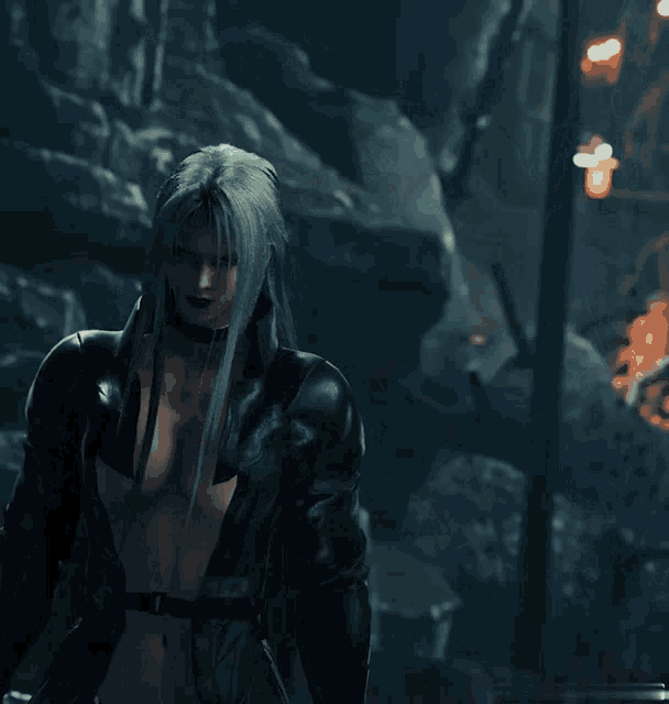 a woman with long grey hair and a choker stands in the dark