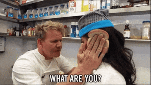 a man is holding a piece of bread over a woman 's ear and asking her what are you