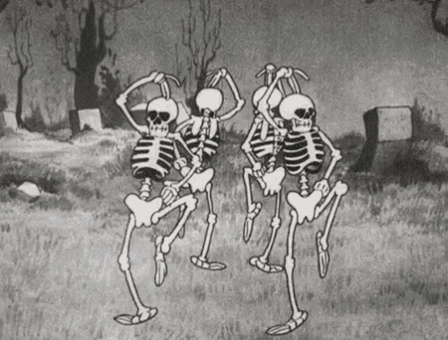 three skeletons are dancing in a cemetery .