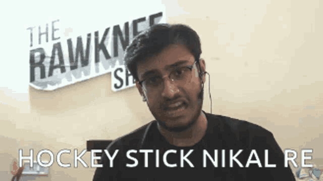 a man wearing glasses and ear buds says hockey stick nikal
