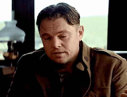 a man in a brown jacket is looking down
