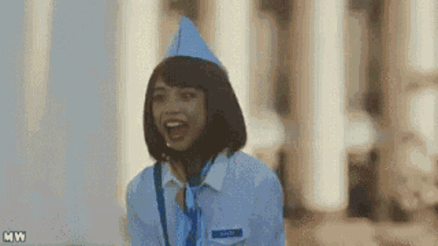 a woman in a stewardess uniform is smiling and laughing .