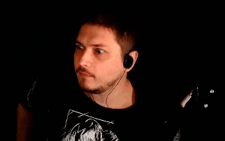 a man with a beard and mustache is wearing headphones .