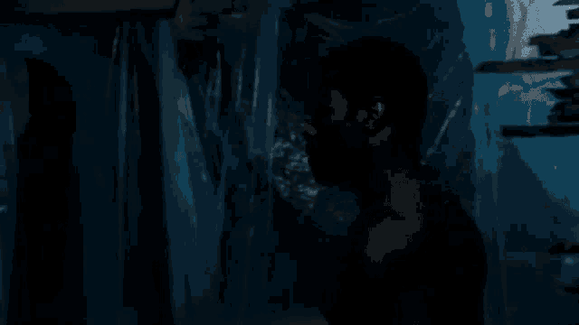 a close up of a person 's face in a plastic bag in a dark room .