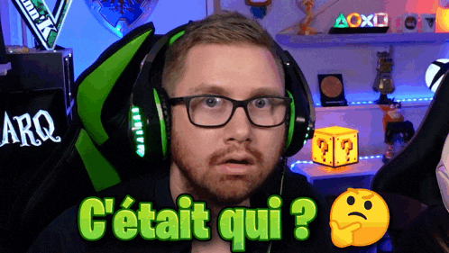 a man wearing glasses and headphones says " c'était qui " in green
