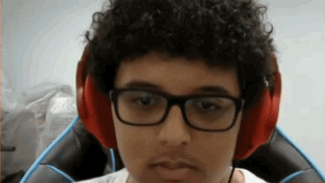 a young man wearing glasses and red headphones