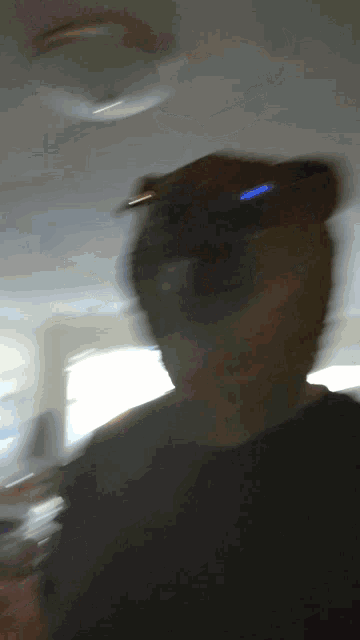 a blurry picture of a person 's face with a light behind them
