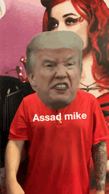 a man wearing a red t-shirt that says assad mike