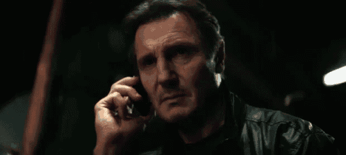 a man talking on a cell phone with the words " good luck " below him