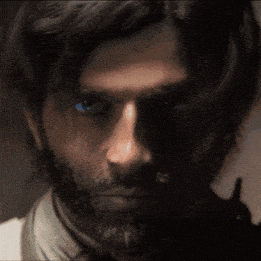 a close up of a person 's blue eye with a dark background
