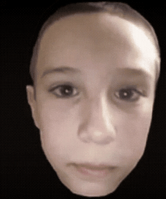 a close up of a child 's face against a black background