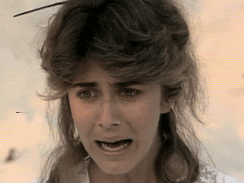 a woman with long hair making a funny face with her mouth open