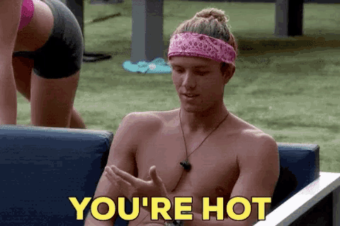 a shirtless man is sitting on a couch with the words you 're hot above him