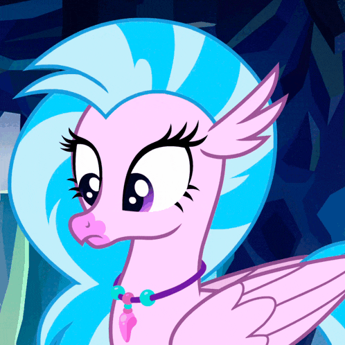 a pink and blue pony with a necklace on