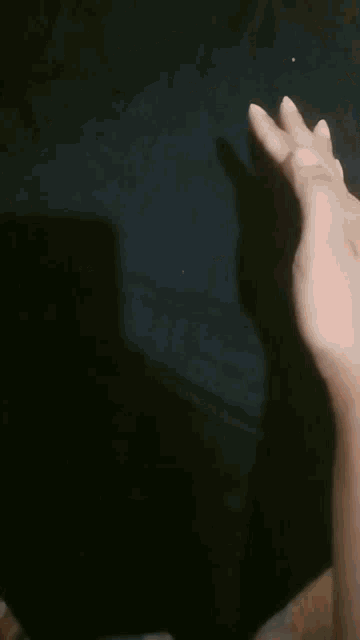 a close up of a person 's face with their mouth open and a hand covering their face .