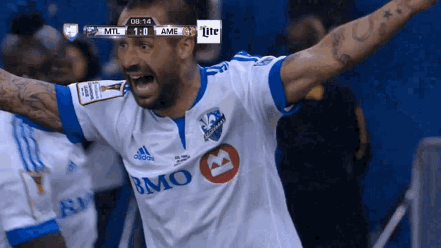 a soccer player wearing a white and blue jersey that says bmo