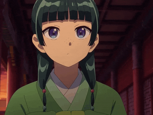 a girl with green hair and purple eyes is looking at the camera