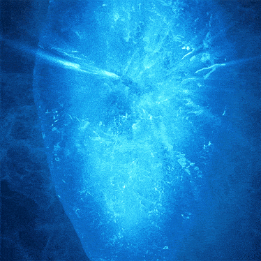 a close up of a blue water surface with bubbles