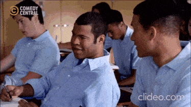 a group of men are sitting in a classroom with comedy central written on the screen