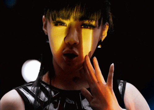 a close up of a woman 's face with a yellow light shining on her