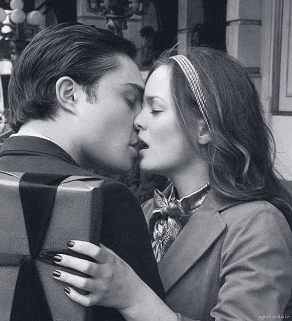 a black and white photo of a man and woman kissing with the caption epic chair