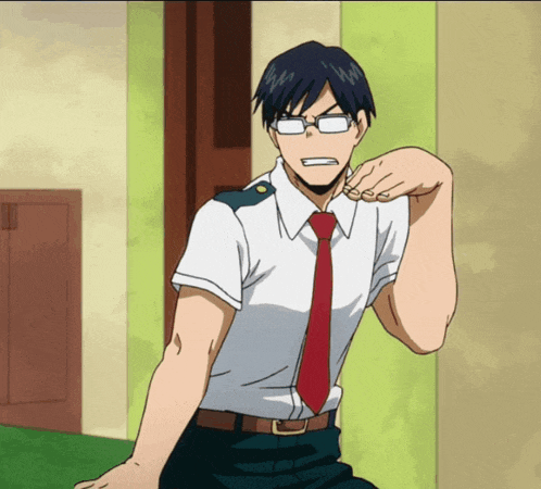 a man wearing glasses and a red tie is sitting on the floor