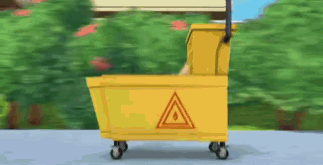 a yellow mop bucket with a red triangle on the side