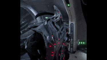 a video game character is standing in a room with a green light