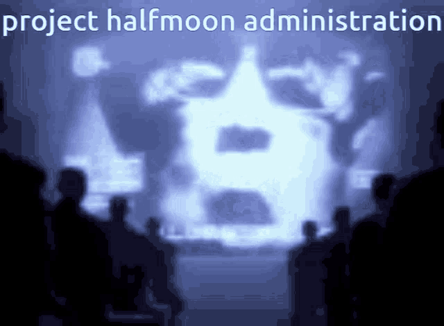 a group of people are standing in front of a projection of a man 's face and the words project halfmoon administration