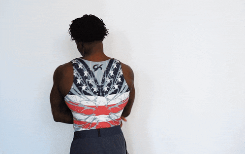 a man is wearing a tank top with an american flag on it