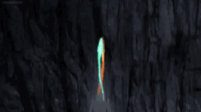 a green and orange arrow is flying towards a planet