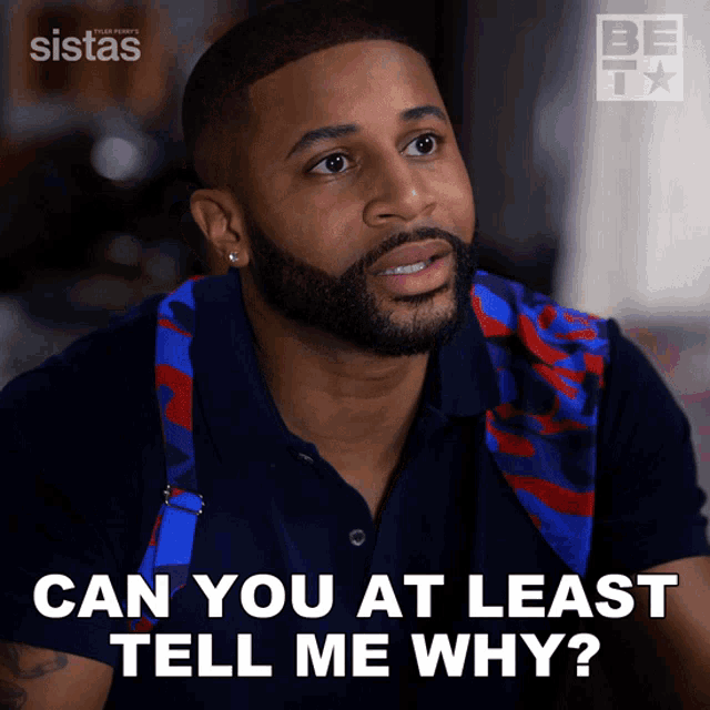 a man with a beard and a backpack says can you at least tell me why