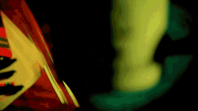 a blurred image of a person 's feet with a red shirt on