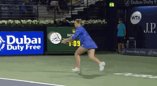 a dubai duty free ad is behind a tennis player