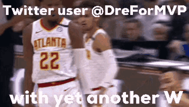 a basketball player with the number 22 on his jersey is walking towards another player