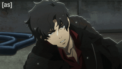 a man in a black jacket with a red shirt and the word [ as ] on the bottom right