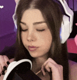 a woman wearing headphones and a nose ring