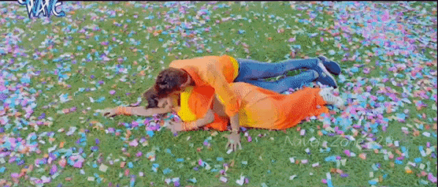 a man and a woman are laying in a field of confetti with the word navel zone written on the bottom