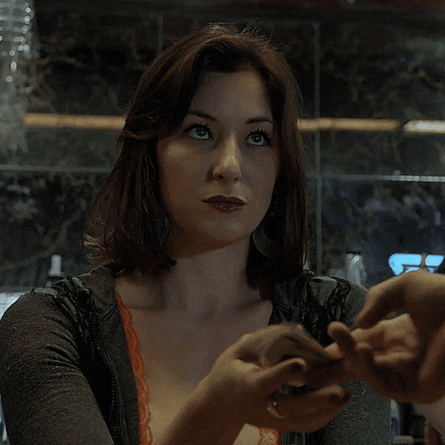 a woman in a gray sweater is looking down